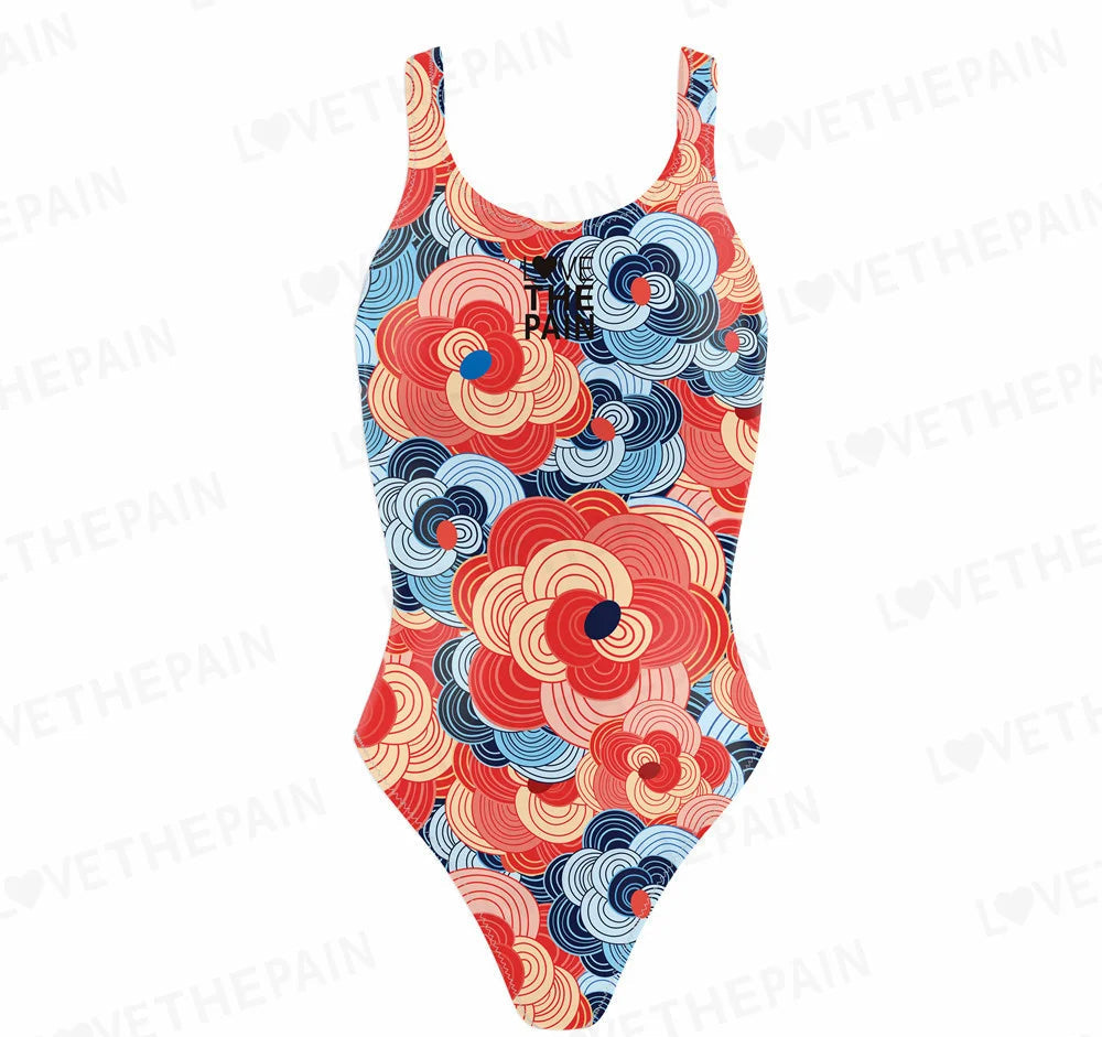 A multicolored women's swimsuit with a geometric pattern, featuring red, blue, and white circles on a white background.