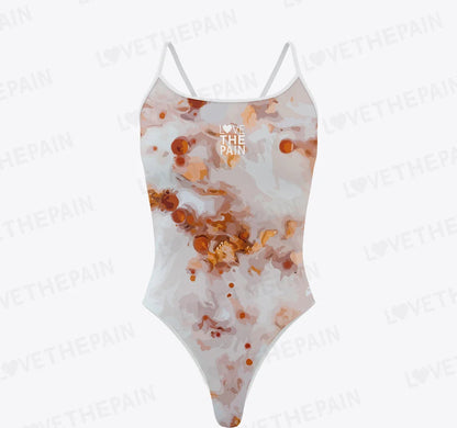 A swimsuit with a marbled multicolor print, predominantly in shades of pink and brown, with a small text logo on the left side.